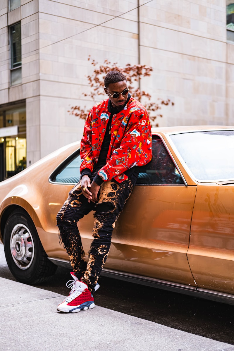 A man sitting on the hood of a car